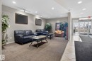 The property features a reception area with recessed lighting, track lighting, and a combination of carpet and tile flooring - 423 2430 Guardian Road, Edmonton, AB  - Indoor 