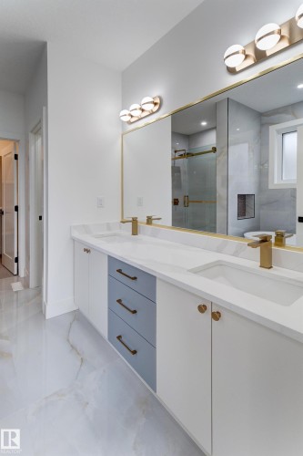 Dual vanity with integrated sinks, quartz countertop, and gold-finish fixtures - 4727 17 Avenue, Edmonton, AB 