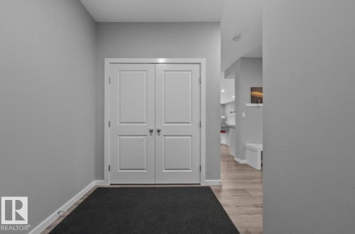 Entryway featuring light gray walls, white trim, and wood-finish flooring - 243 39 Avenue Nw, Edmonton, AB - Indoor Photo Showing Other Room