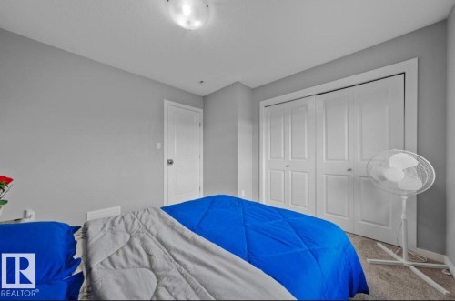 Bedroom with neutral gray walls, flush-mount ceiling light, and carpeted flooring - 243 39 Avenue Nw, Edmonton, AB - Indoor Photo Showing Bedroom