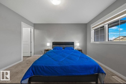 Carpeted room featuring light gray walls, a ceiling-mounted light fixture, white trim, and a window with white blinds - 243 39 Avenue Nw, Edmonton, AB - Indoor Photo Showing Bedroom