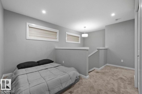 Carpeted room featuring light gray walls and white trim - 243 39 Avenue Nw, Edmonton, AB - Indoor Photo Showing Bedroom