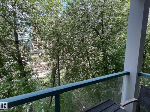 Balcony featuring a glass panel railing and a painted support column - 304 10011 110 Street, Edmonton, AB - Outdoor