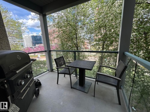 Private balcony featuring a concrete floor and clear glass railing - 304 10011 110 Street, Edmonton, AB - Outdoor With Exterior