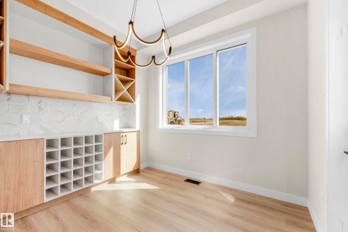 Built-in cabinetry featuring open shelving, wine rack storage, and lower cabinets - 4915 17 Avenue, Edmonton, AB - Indoor Photo Showing Other Room