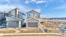 Modern architectural facade with a two-tone siding exterior, prominent front-facing garage, multi-pane windows, and a sloped roofline - 4915 17 Avenue, Edmonton, AB  - Outdoor 