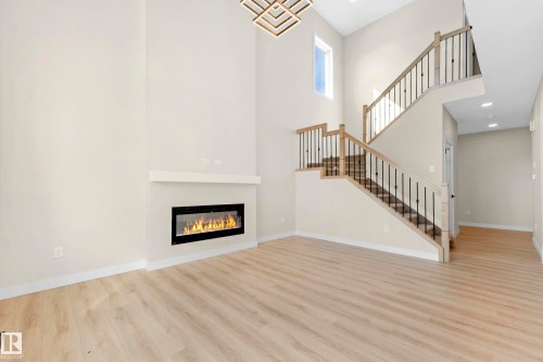 Two-story interior with light wood-finish flooring - 4915 17 Avenue, Edmonton, AB - Indoor With Fireplace