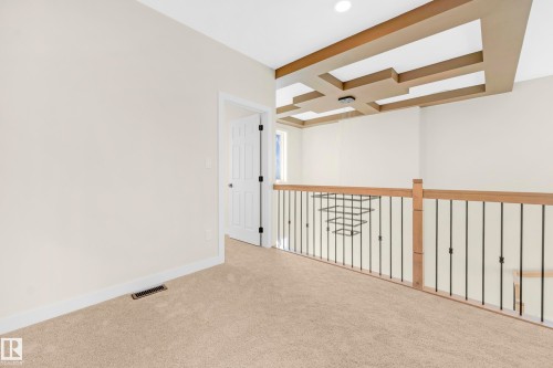Second-story landing with neutral carpeting and a white trim baseboard - 4915 17 Avenue, Edmonton, AB - Indoor Photo Showing Other Room