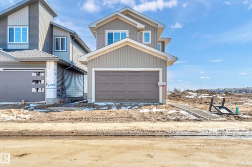 Contemporary single-family residence featuring a two-story design with light gray vertical and horizontal siding - 4915 17 Avenue, Edmonton, AB - Outdoor
