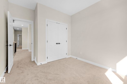 Carpeted room with neutral wall tones and white trim - 4915 17 Avenue, Edmonton, AB - Indoor Photo Showing Other Room