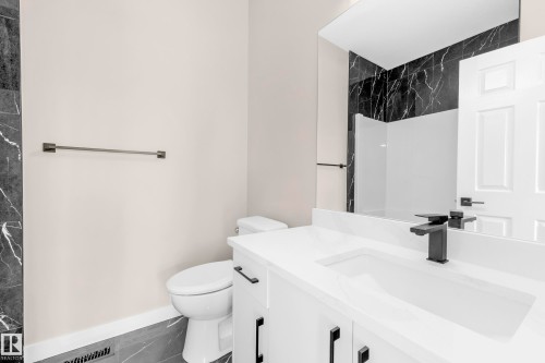 Modern bathroom featuring a single white vanity with an integrated sink and matte black hardware - 4915 17 Avenue, Edmonton, AB - Indoor Photo Showing Bathroom