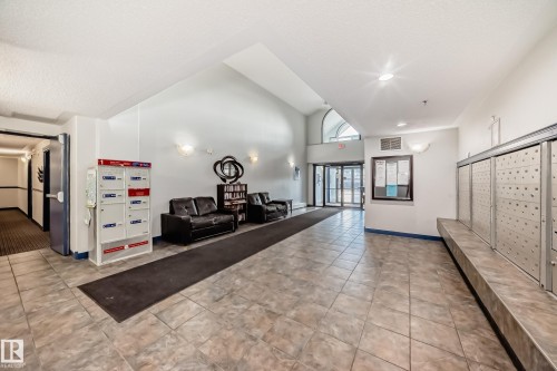 Building common area with tile flooring and high ceilings - 210 2305 35A Avenue, Edmonton, AB - Indoor Photo Showing Other Room