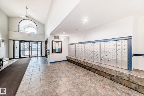 Entryway featuring a vaulted ceiling with a ceiling fan and a prominent arched window above the main entrance - 210 2305 35A Avenue, Edmonton, AB - Indoor Photo Showing Other Room