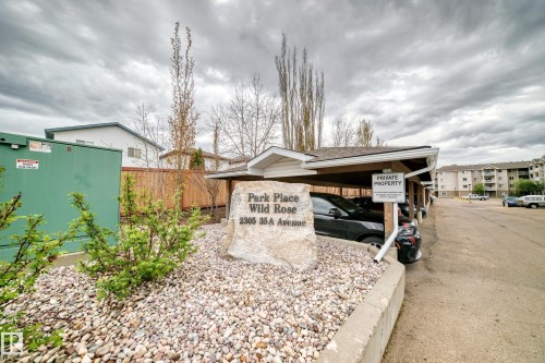 Carport parking with a shingled roof and white soffit - 210 2305 35A Avenue, Edmonton, AB - Outdoor