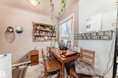This room features a window providing natural light, a wooden table, and wooden chairs - 7723 82 Avenue, Edmonton, AB - Indoor Photo Showing Dining Room