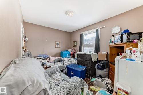 The room features a window with dark curtains, a ceiling light fixture, and walls painted in a neutral tone - 7723 82 Avenue, Edmonton, AB - Indoor