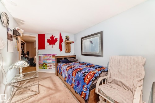 This room features light blue walls and carpeting - 7723 82 Avenue, Edmonton, AB - Indoor Photo Showing Bedroom