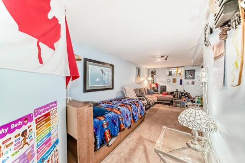 Versatile room featuring light blue walls, recessed lighting, and a window providing natural light - 7723 82 Avenue, Edmonton, AB - Indoor Photo Showing Bedroom