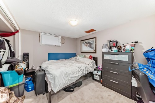 Bedroom featuring light-colored walls and carpeted flooring - 7723 82 Avenue, Edmonton, AB - Indoor Photo Showing Bedroom