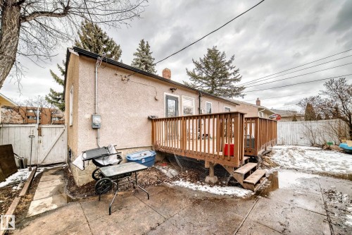 The property features a rear deck with wooden railings, providing outdoor living space - 7723 82 Avenue, Edmonton, AB - Outdoor With Deck Patio Veranda