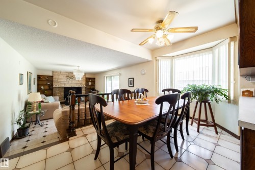 Dining area featuring geometric tile flooring and a bay window with vertical blinds - 8509 39B Avenue, Edmonton, AB - Indoor Photo Showing Dining Room