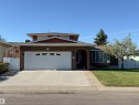 Brick facade residence featuring a two-car garage with decorative windows and an arched entry - 8509 39B Avenue, Edmonton, AB  - Outdoor With Facade 