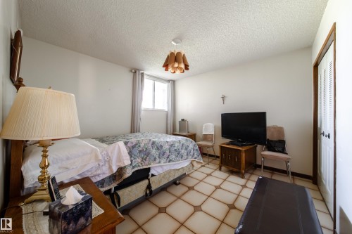 Bedroom with patterned floor tile, white walls, and a single window - 8509 39B Avenue, Edmonton, AB - Indoor Photo Showing Bedroom