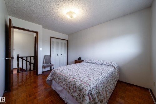 Room featuring wood parquet flooring, white walls, and a ceiling-mounted light fixture - 8509 39B Avenue, Edmonton, AB - Indoor Photo Showing Bedroom