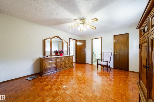 Spacious interior room featuring parquet wood-finish flooring, white walls, and a ceiling fan with integrated lighting - 8509 39B Avenue, Edmonton, AB - Indoor Photo Showing Other Room