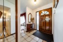 Entryway featuring a wood-panel door with decorative glass, frosted sidelight, and an arched transom window - 8509 39B Avenue, Edmonton, AB  - Indoor Photo Showing Other Room 