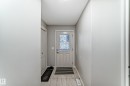 Entryway featuring patterned glass door, light-toned tile flooring, recessed ceiling light fixture, and white bi-fold closet doors - 6419 18 Avenue, Edmonton, AB  - Indoor Photo Showing Other Room 