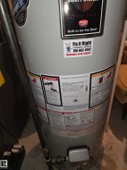 New hot water heater installed 2019 with visible energy-saving features and professional service labeling - 