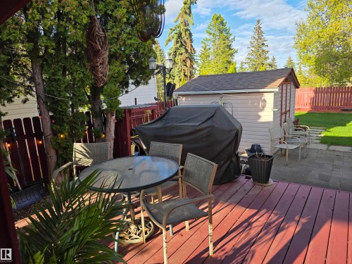 Expansive outdoor deck featuring wood flooring and a glass-top table - 25 Mcnabb Crescent, Stony Plain, AB - Outdoor With Deck Patio Veranda With Exterior