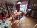 Dining area featuring wood-finish flooring, a decorative pendant light fixture, and a large window - 25 Mcnabb Crescent, Stony Plain, AB  - Indoor Photo Showing Dining Room 