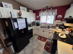 Kitchen featuring white cabinetry and light-toned countertops - 