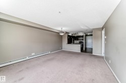 Expansive living area with carpeting and neutral-toned walls - 