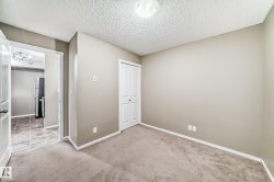Neutral-toned walls complement the gray carpet flooring - 