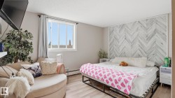 Interior room featuring light wood-finish flooring and a herringbone accent wall - 