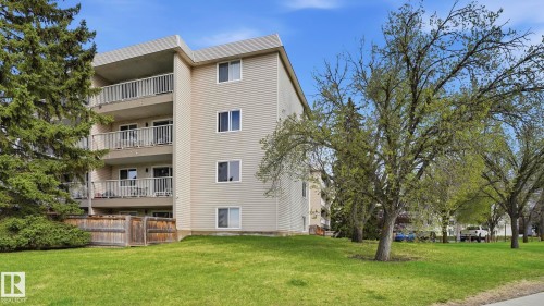 Multi-story building featuring light-colored siding and multiple private balconies with white railings - 105 5125 Riverbend Road, Edmonton, AB - Outdoor