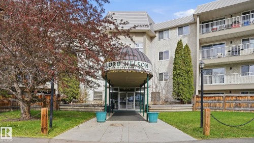 Multi-story building featuring a covered entrance with a "Lord Nelson" sign - 105 5125 Riverbend Road, Edmonton, AB - Outdoor