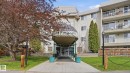 Multi-story building featuring a covered entrance with a "Lord Nelson" sign - 105 5125 Riverbend Road, Edmonton, AB  - Outdoor 
