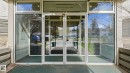 Glass entry doors with transom windows and sidelights - 105 5125 Riverbend Road, Edmonton, AB  -  With Exterior 