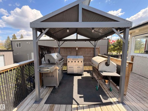 Spacious exterior deck featuring a covered gazebo with integrated lighting - 5510 Railway Avenue, Glendon, AB - Outdoor With Deck Patio Veranda With Exterior