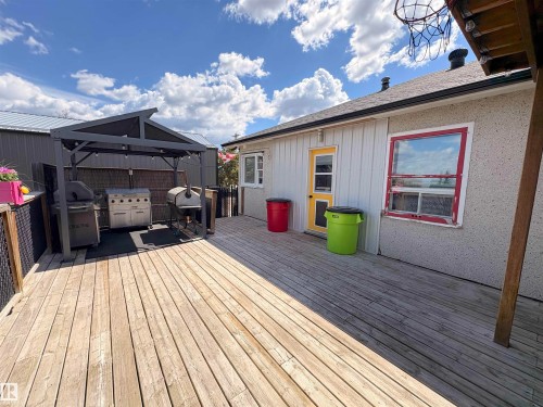 Expansive wood-finish deck with a built-in gazebo featuring integrated lighting - 5510 Railway Avenue, Glendon, AB - Outdoor With Deck Patio Veranda With Exterior