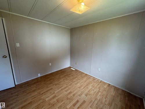 Room featuring wood-finish flooring and neutral-toned wall paneling - #46 4204 47 St, Wetaskiwin, AB - Indoor Photo Showing Other Room