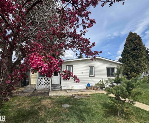 Single-story residence featuring light-colored horizontal siding and dark-trimmed windows - #46 4204 47 St, Wetaskiwin, AB - Outdoor
