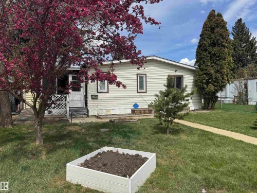 Single-story residence featuring light-colored horizontal siding and dark trim windows - #46 4204 47 St, Wetaskiwin, AB - Outdoor