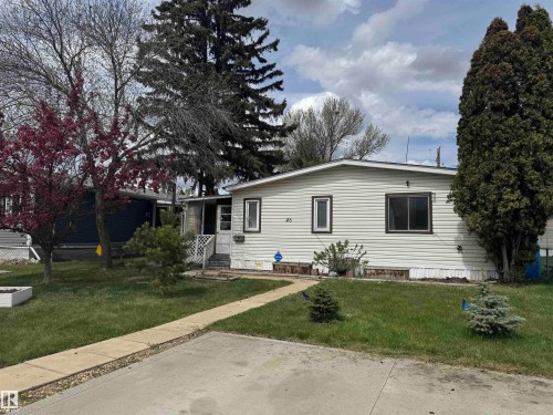 Single-story residence featuring light-colored horizontal siding and dark-framed windows - #46 4204 47 St, Wetaskiwin, AB - Outdoor