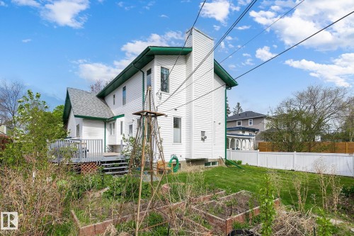 Rear exterior featuring white siding with green trim - 10823 130 Street, Edmonton, AB - Outdoor With Deck Patio Veranda