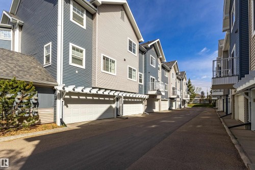 Contemporary townhome exteriors featuring horizontal siding in varied blue and gray tones - 41 8304 11 Avenue, Edmonton, AB - Outdoor
